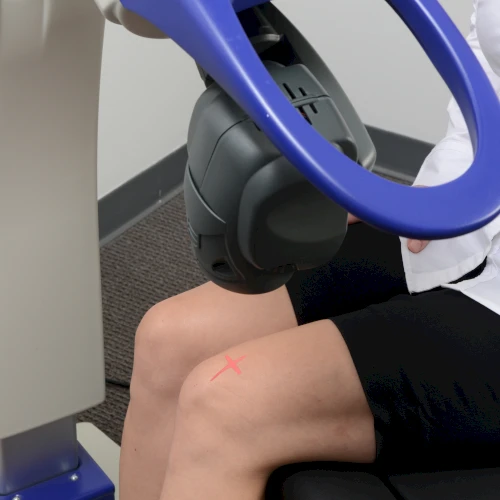 MLS M6 laser applied to a seated client's knee