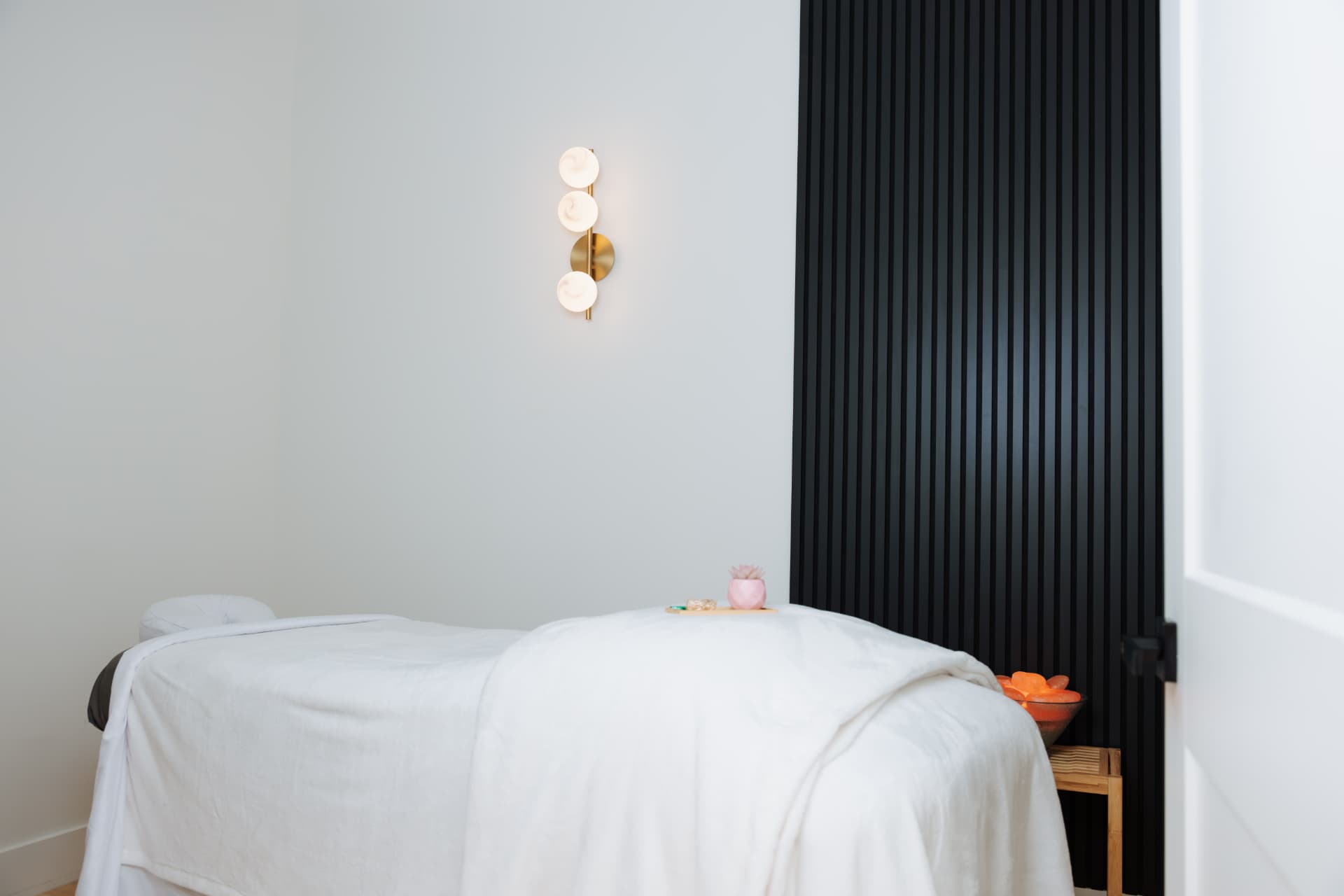 Massage therapist working on a client's shoulders on a massage table